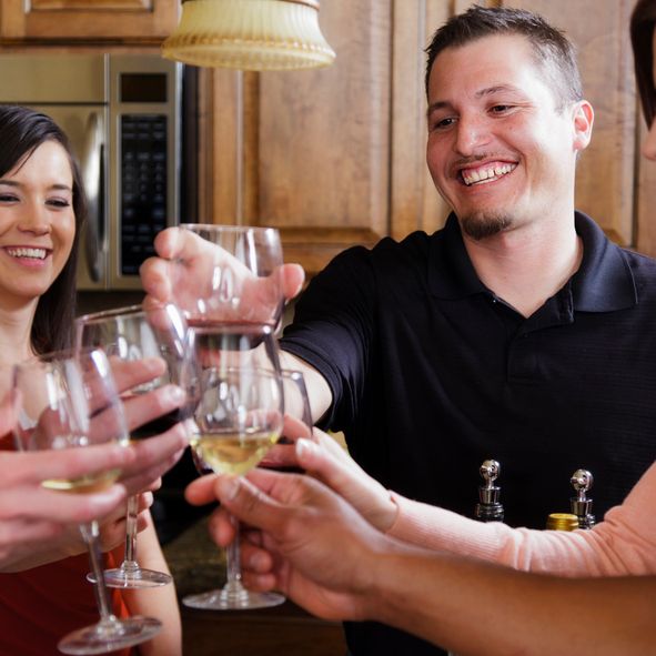 A woman with freckled hair holding a bottle of cream.